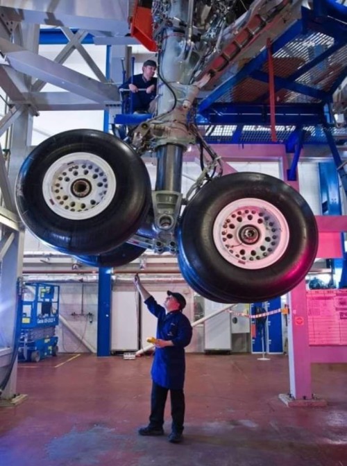 Engineer working on site with airplane in the background
