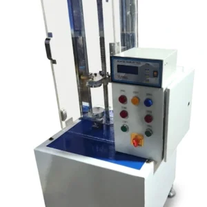 "Industrial spring tester measuring force and displacement of a compression spring."